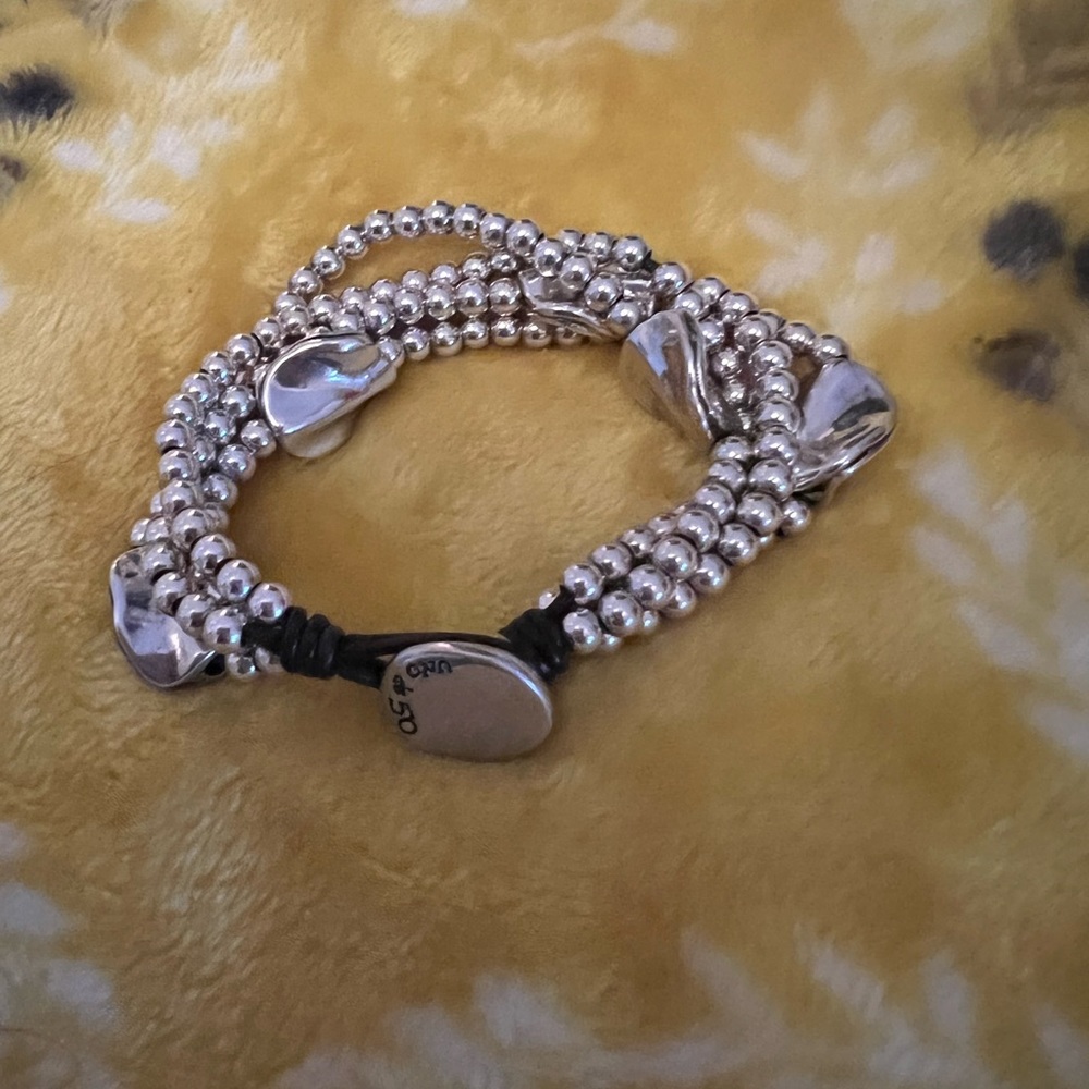 UNO de 50 “ A Beautiful Mind “ bracelet. Sterling silver blend and leather.